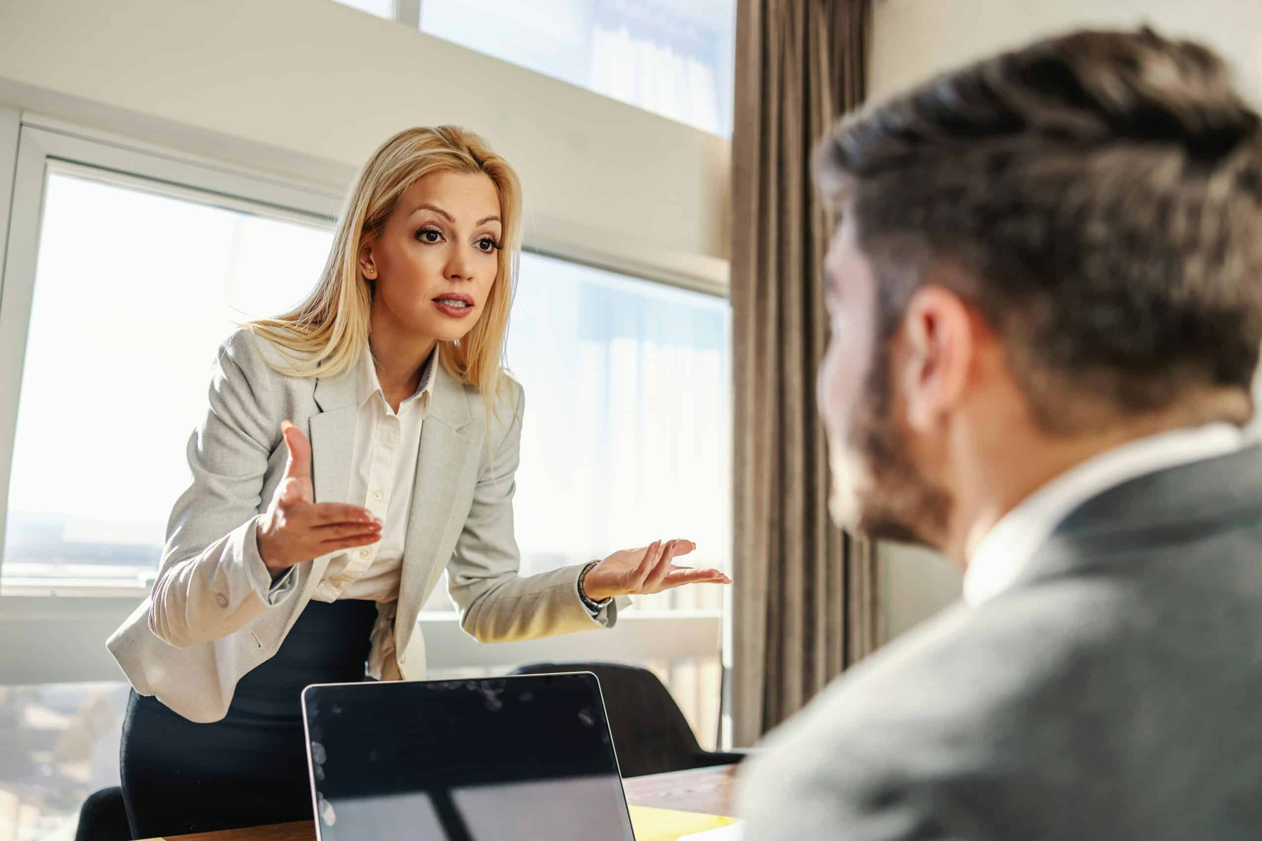 Frustrated Business Professional (Woman) is Arguing with another Business Professional