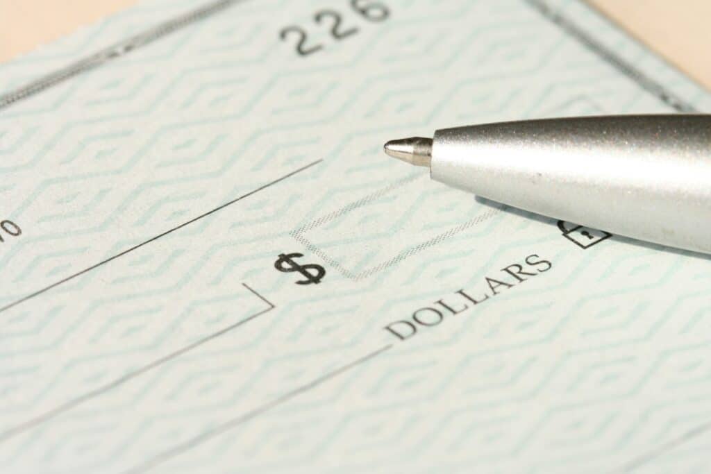 a pen sitting on top of a blank cheque