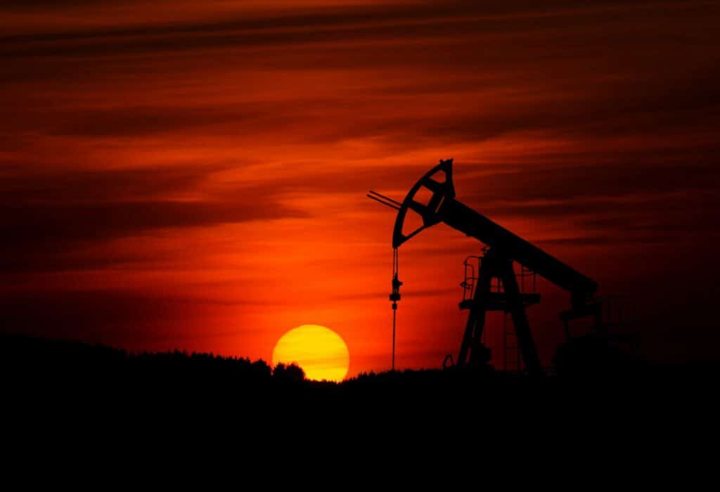 Pump-jack mining oil at sunset, representing knock for knock clauses and oil and gas.