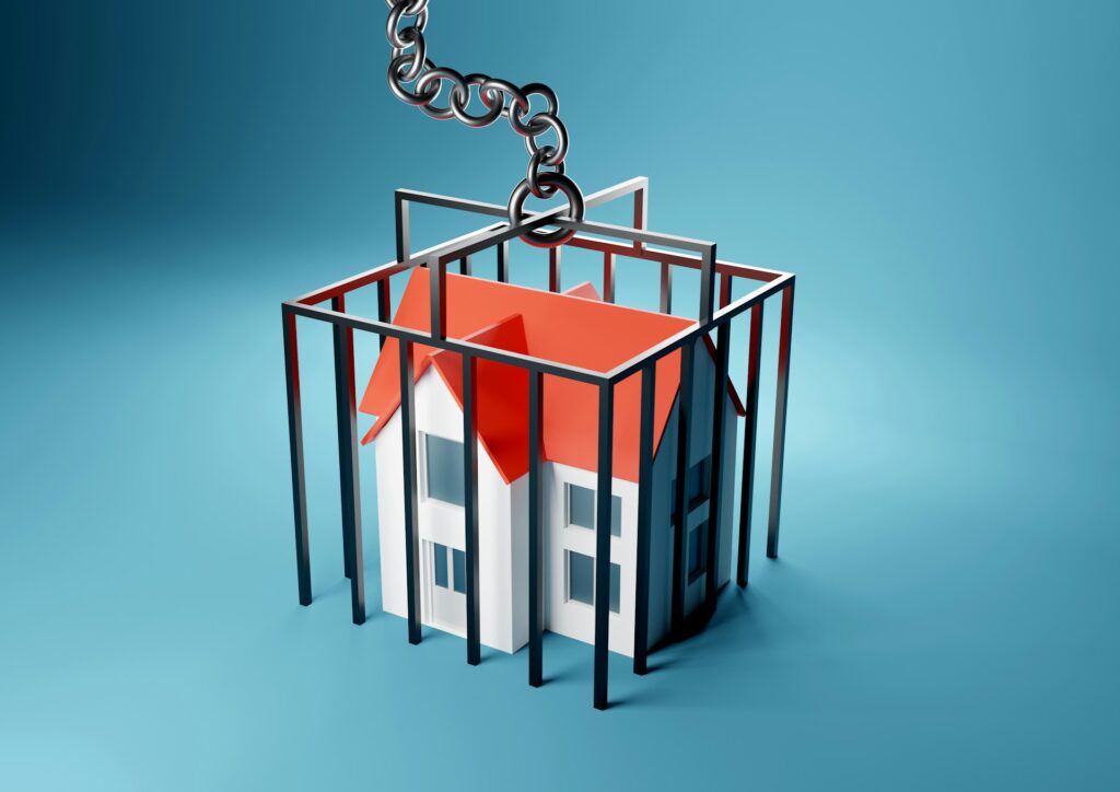 An illustration of a house in a cage, representing foreclosure.