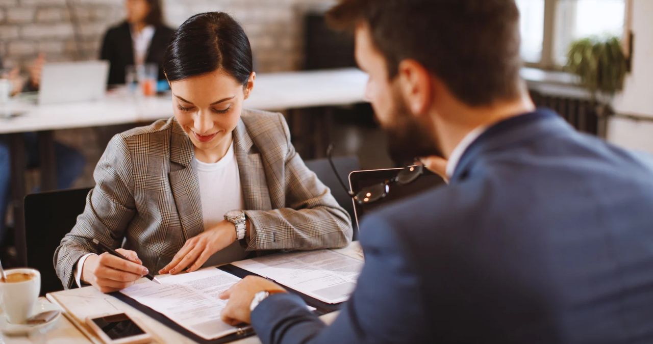 Employment agreement being reviewed and signed in a professional office